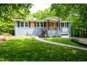 Lovely home featuring a well-manicured lawn and inviting entrance with wood detailing at 529 Orindo Dr, Durham, NC 27713