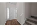 Bright entryway featuring wood-look flooring and carpeted stairs at 604 Oakfield Trl, Mebane, NC 27302