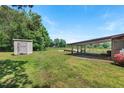 Expansive backyard with a shed, carport, and green space at 620 Mcghees Mill Rd, Roxboro, NC 27574