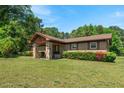 Single-story home with stone entrance, tidy landscaping, and a well-maintained lawn at 620 Mcghees Mill Rd, Roxboro, NC 27574