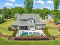 Aerial view of private backyard with a pool, jacuzzi, and landscaping at 6208 Old Miravalle Ct, Raleigh, NC 27614