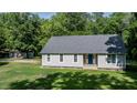 View of this home's exterior shows its large yard and a separate storage shed at 726 Thomas Rd, Rocky Mount, NC 27801