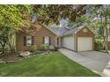 Well-maintained brick home offering a two-car garage, lush landscaping, and a welcoming curb appeal at 900 Finchurch Cir, Wake Forest, NC 27587