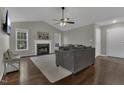 Inviting living room featuring a cozy fireplace, hardwood floors, and plenty of natural light at 900 Finchurch Cir, Wake Forest, NC 27587