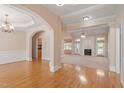 Spacious living room with hardwood floors and large arches into other rooms at 97 Rand Rd, Raleigh, NC 27603
