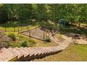 A backyard featuring a garden area, fire pit and views of the encompassing forest at 9701 Precious Stone Dr, Wake Forest, NC 27587