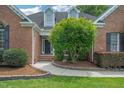 Inviting brick home with a landscaped walkway leading to the front door at 1 Plowlan Ct, Durham, NC 27707