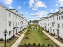 Community features a central green space, sidewalks, and attractive home exteriors at 104 Vallco Ln, Durham, NC 27713