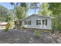 Inviting one-story home with vinyl siding, a brick accent, and a small front yard with landscaping at 106 Argyle Ct, Garner, NC 27529