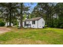 A charming brick home surrounded by trees, with a well-maintained lawn and landscaping at 109 Riverbend Dr, Archer Lodge, NC 27527