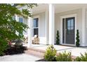 Inviting front porch with brick steps and a seating area, perfect for relaxing outdoors at 1102 Birchbark Rd, Durham, NC 27705