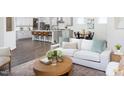Open-concept living room with a cozy seating area and a view of the modern kitchen at 1102 Birchbark Rd, Durham, NC 27705