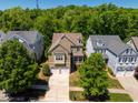 Beautiful suburban home featuring a two-car garage, mature trees, and well-maintained landscaping at 113 Ruskin Dr, Chapel Hill, NC 27516