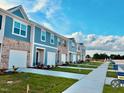 Beautiful new townhomes with brick and siding, integrated garages, and manicured lawns in a desirable community at 115 N Chubb Rdg, Wilson's Mills, NC 27520