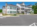 Beautiful condo building with multiple balconies, brick accents, and well-manicured landscaping at 11549 Helmond Way # 107, Raleigh, NC 27617
