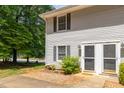 Charming townhouse exterior with light gray siding, black shutters and a well-maintained front yard at 1223 Jamestown Ct, Cary, NC 27511