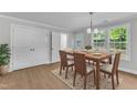 Dining area with natural wood table set, white walls, and natural light at 129 Davis St, Louisburg, NC 27549