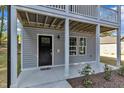 The lower level includes a black door, two windows, and a new welcome mat at 129 Davis St, Louisburg, NC 27549