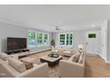 Bright living room with multiple windows, neutral walls, and comfortable seating area at 129 Davis St, Louisburg, NC 27549