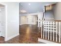 Spacious living room with hardwood floors, a staircase, and large windows providing ample natural light at 149 Wards Ridge Dr, Cary, NC 27513