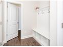 Convenient mudroom area with a built-in bench, coat hooks, and shelving for easy organization at 149 Wards Ridge Dr, Cary, NC 27513