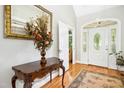 Welcoming entryway features hardwood floors, a decorative rug, and an elegant doorway at 150 Georgetown Woods Dr, Youngsville, NC 27596