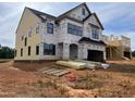 New construction featuring black trim windows and a two car garage on a large lot at 1609 Malcus Ct # 67, Fuquay Varina, NC 27526