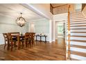 Formal dining room featuring hardwood floors, wainscotting and statement light fixture at 1820 Yates Wheel Way, Raleigh, NC 27606