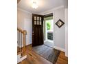 Warm foyer with hardwood floors, open doorway, and stylish decor creating a welcoming entrance at 1820 Yates Wheel Way, Raleigh, NC 27606