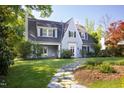 Beautiful exterior elevation showcasing a well-maintained lawn and a traditional home design with classic architectural details at 19 Oak Dr, Durham, NC 27707