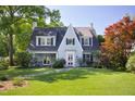 Inviting exterior view of home, with a well-manicured lawn, mature trees, and classic architectural details at 19 Oak Dr, Durham, NC 27707