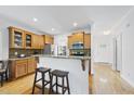Kitchen features light wood cabinets, granite countertops, and stainless steel appliances at 20 Paddy Ln, Youngsville, NC 27596
