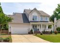 Charming two-story home featuring a garage and covered front porch with curb appeal at 2013 Waterton Ln, Apex, NC 27502
