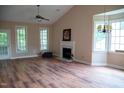 Bright living room with fireplace, hardwood floors, and large windows offering plenty of natural light at 205 Windbyrne Dr, Cary, NC 27513