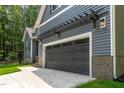 A beautiful two car garage attached to the house with a concrete driveway at 249 Rawhide Dr, Louisburg, NC 27549