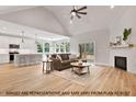Bright, open living room with fireplace, hardwood floors, and seamless flow to the kitchen at 249 Rawhide Dr, Louisburg, NC 27549