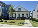 Inviting single-story home featuring a covered front porch, well-maintained lawn, and freshly planted tree at 2874 Quarry Rd # 165, Rolesville, NC 27571