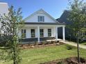 Beautiful white single-story home with a covered porch, manicured lawn, and an inviting entryway at 2874 Quarry Rd # 165, Rolesville, NC 27571