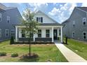 Inviting single-Gathering home featuring a classic facade, covered porch, and manicured lawn at 2874 Quarry Rd # 165, Rolesville, NC 27571