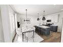 Open-concept kitchen and dining area featuring a large island with bar stools and a dining table at 2911 Alyssa Ct, Raleigh, NC 27604