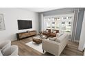 Cozy living room with hardwood floors, large windows, and stylish furnishings at 2915 Alyssa Ct, Raleigh, NC 27604