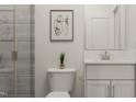 Modern bathroom featuring a sleek vanity, tiled shower, and contemporary fixtures at 312 Calvander Ln, Apex, NC 27539