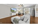 Comfortable living room with hardwood floors, a plush sofa, and plenty of natural light at 322 Brier Crossings Loop, Durham, NC 27703