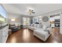Bright living room featuring hardwood floors, a ceiling fan, and a comfortable seating area at 322 Brier Crossings Loop, Durham, NC 27703