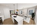 Open concept kitchen and dining area with modern finishes and lots of natural light at 332 Cottage Hl, Knightdale, NC 27604