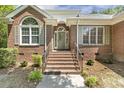 Inviting brick home entrance with a classic door and manicured landscaping at 3404 Apple Meadow Dr, Fuquay Varina, NC 27526