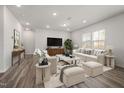 Spacious living room with neutral decor, hardwood flooring, large windows, and comfortable seating at 353 Bridle Brook Way, Fuquay Varina, NC 27526