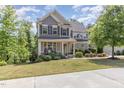 Charming two-story home with a welcoming front porch and mature landscaping at 3609 Jordan Shires Dr, New Hill, NC 27562