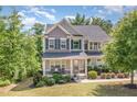 Charming two-story home featuring a welcoming front porch and professionally landscaped yard at 3609 Jordan Shires Dr, New Hill, NC 27562