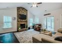 Spacious living room featuring a stone fireplace, ceiling fan, and hardwood floors at 4072 Mackenzie Dr, Haw River, NC 27258
